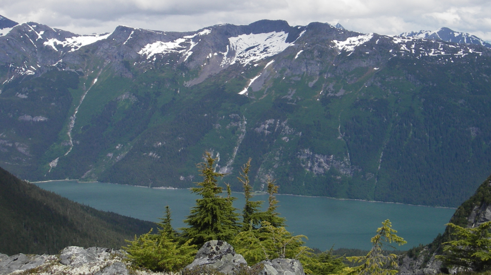 The trail stretches across an alpine wonderland above the fjord