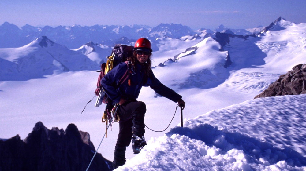 Company founder Sean Gaffney crestin a summit ridge on the upper Davidson Glacier
